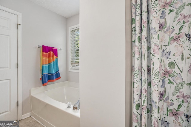 bathroom featuring a bathtub and a textured ceiling