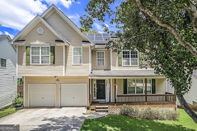 front of property with covered porch, solar panels, a garage, and a front lawn