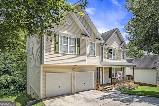 front facade featuring covered porch and a garage