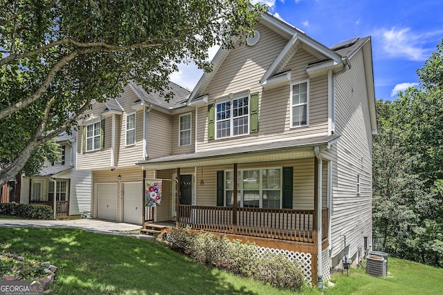 view of front of home featuring cooling unit, a front lawn, a porch, and a garage