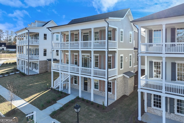 exterior space featuring a lawn and a balcony