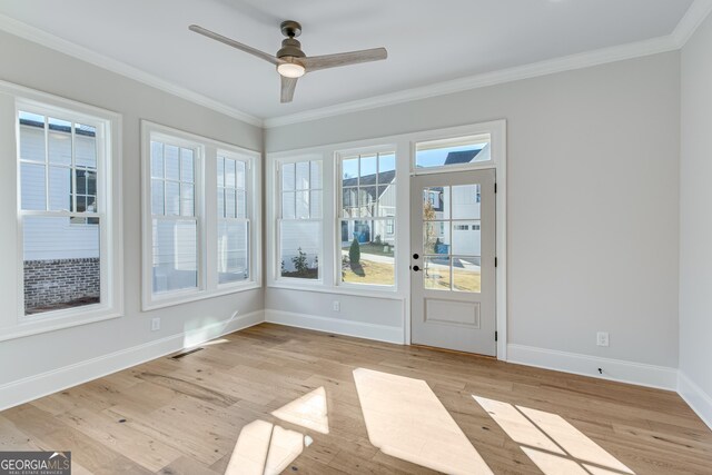 unfurnished sunroom featuring ceiling fan