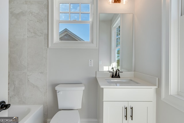 bathroom featuring vanity, toilet, and a wealth of natural light