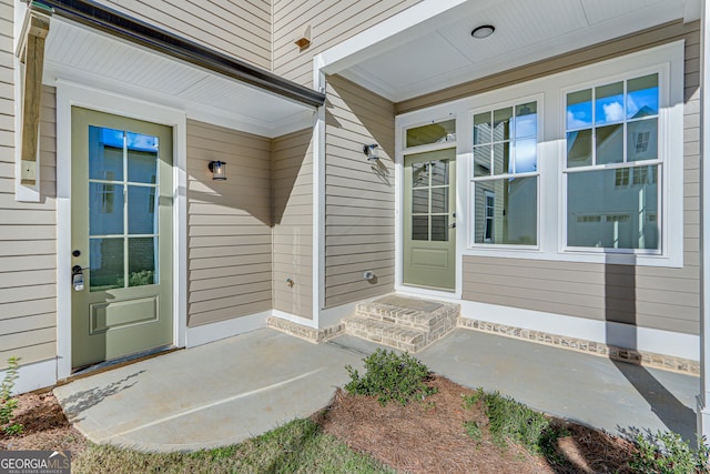 view of exterior entry with covered porch