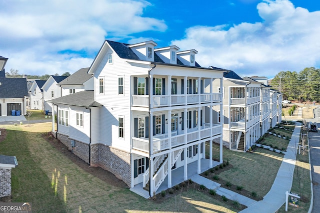 exterior space with a yard, a patio area, and a balcony