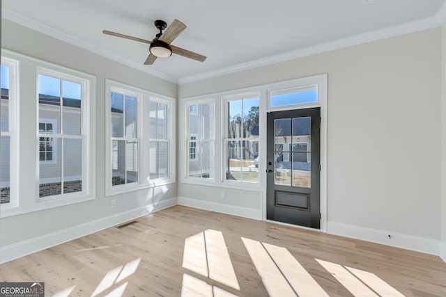 unfurnished sunroom with a wealth of natural light and ceiling fan