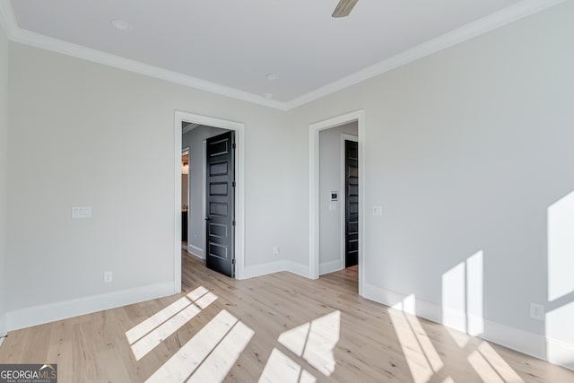 empty room featuring crown molding, ceiling fan, and light hardwood / wood-style floors