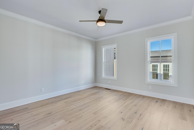 empty room featuring crown molding, ceiling fan, and light hardwood / wood-style floors