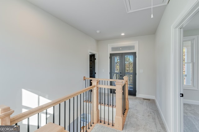 hallway featuring light colored carpet