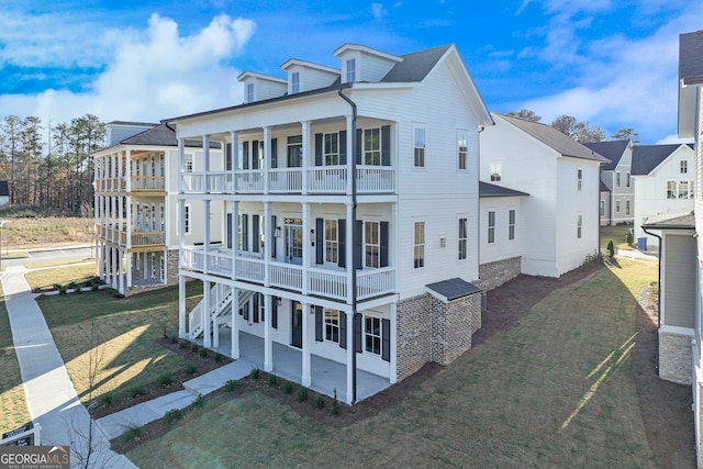 exterior space with a patio area, a balcony, and a yard