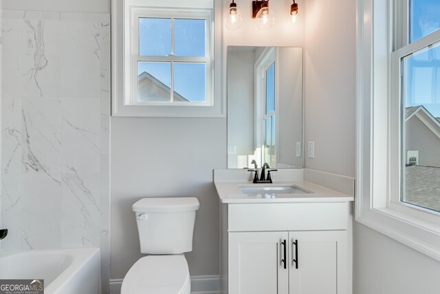 full bathroom featuring vanity, toilet, a wealth of natural light, and tiled shower / bath combo