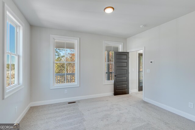 unfurnished room with light colored carpet