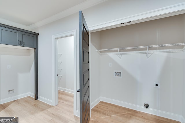 laundry room featuring hardwood / wood-style flooring, hookup for an electric dryer, and cabinets