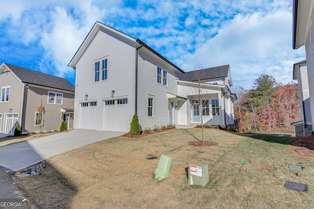 view of front of property featuring a front yard and a garage