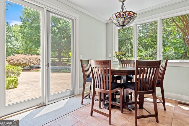 tiled dining room with ornamental molding