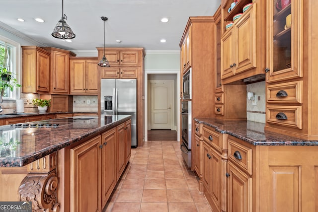 kitchen with dark stone countertops, a center island, tasteful backsplash, and hanging light fixtures