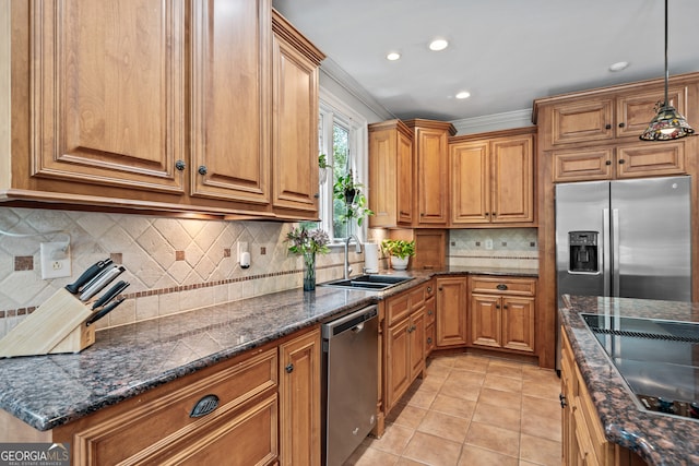 kitchen featuring light tile patterned flooring, tasteful backsplash, stainless steel appliances, decorative light fixtures, and sink