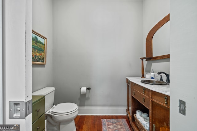 bathroom with vanity, hardwood / wood-style flooring, and toilet