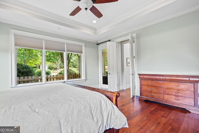 bedroom featuring dark hardwood / wood-style flooring, ceiling fan, a raised ceiling, and crown molding