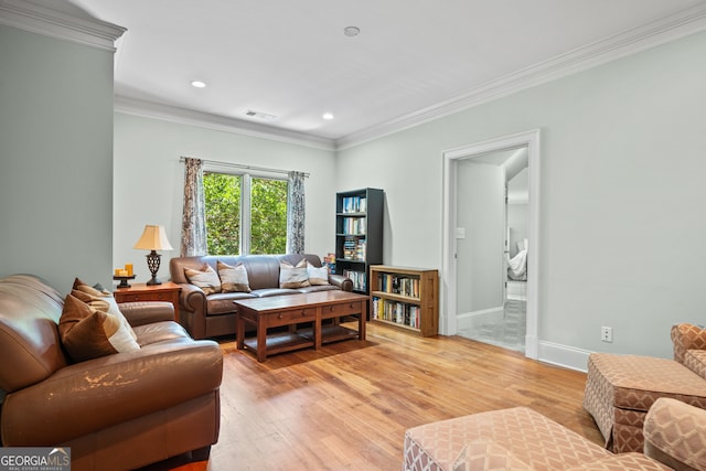 living room with light hardwood / wood-style floors and ornamental molding