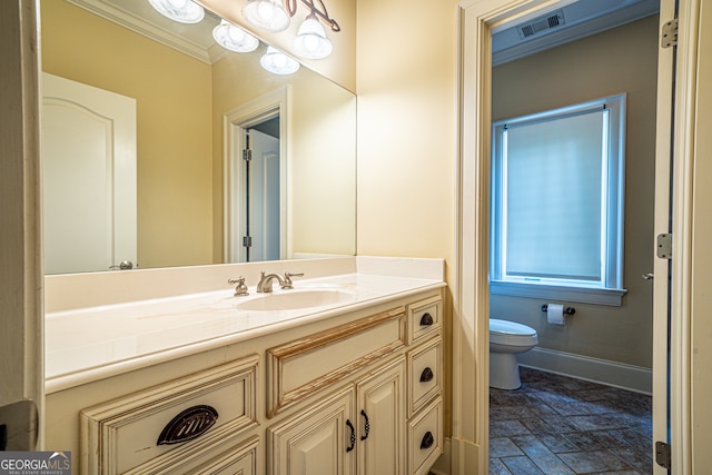 bathroom with vanity, crown molding, toilet, and tile patterned flooring