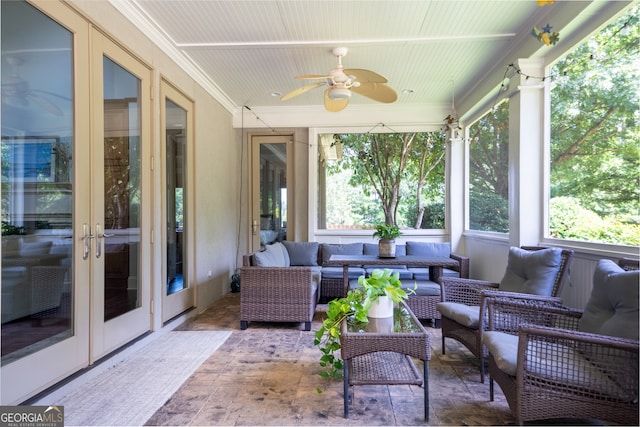 sunroom / solarium featuring ceiling fan and french doors