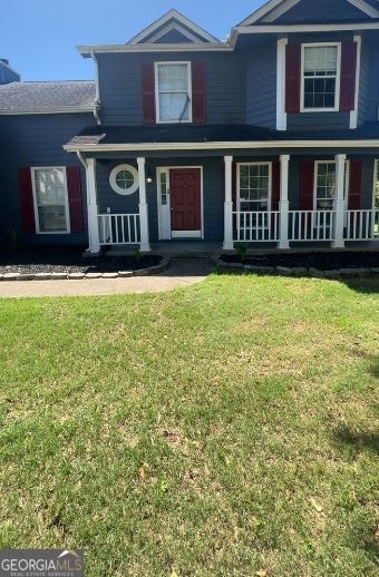 view of front facade with covered porch and a front yard