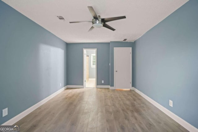 unfurnished room featuring hardwood / wood-style flooring, a textured ceiling, and ceiling fan