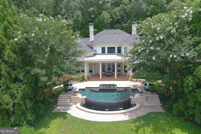 view of swimming pool with a patio and an in ground hot tub