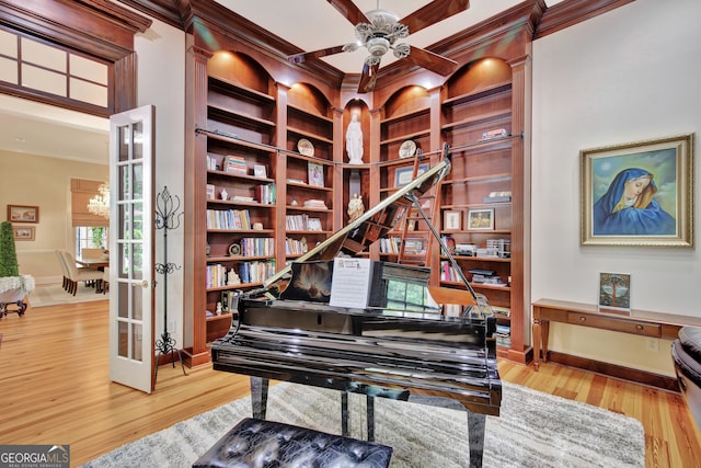 miscellaneous room featuring a healthy amount of sunlight, hardwood / wood-style flooring, and ornamental molding