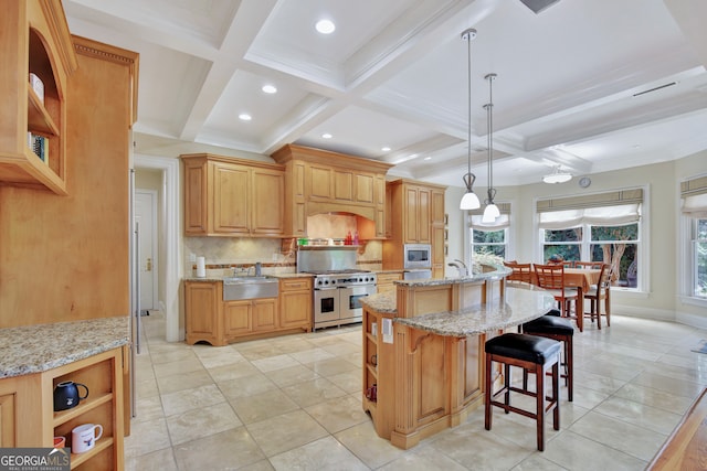 kitchen with hanging light fixtures, a center island with sink, beamed ceiling, sink, and stainless steel appliances