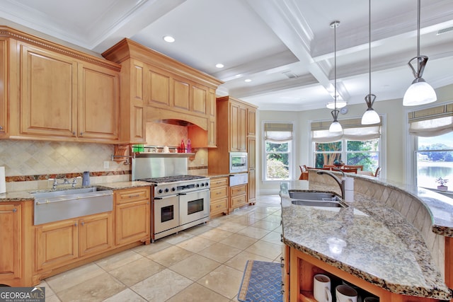 kitchen featuring coffered ceiling, beam ceiling, sink, pendant lighting, and appliances with stainless steel finishes