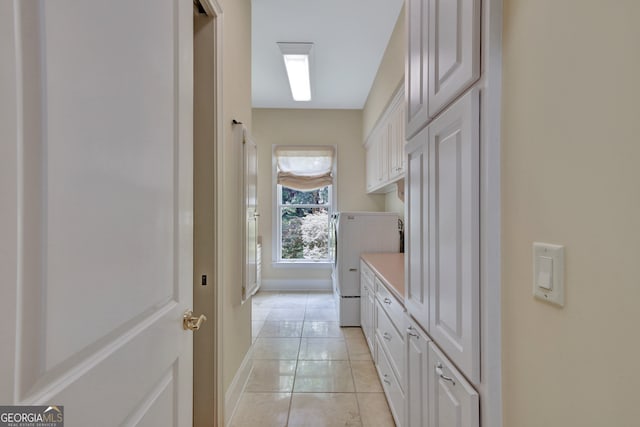 bathroom featuring washer / dryer and tile patterned floors