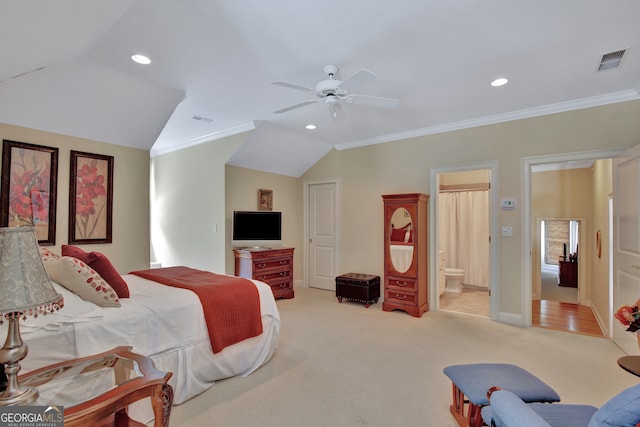 carpeted bedroom featuring ornamental molding, ensuite bath, vaulted ceiling, and ceiling fan