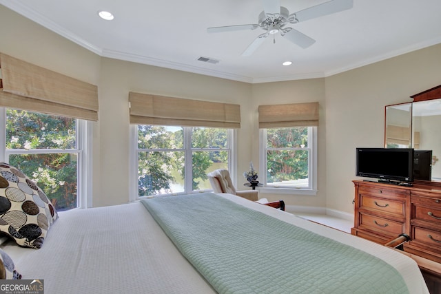 bedroom with ornamental molding and ceiling fan