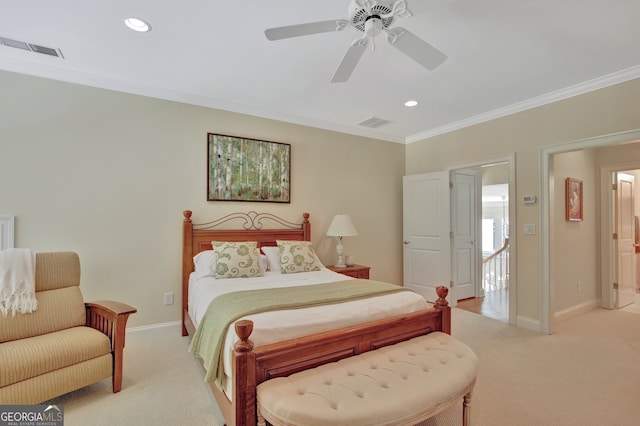 bedroom with ornamental molding, light colored carpet, and ceiling fan