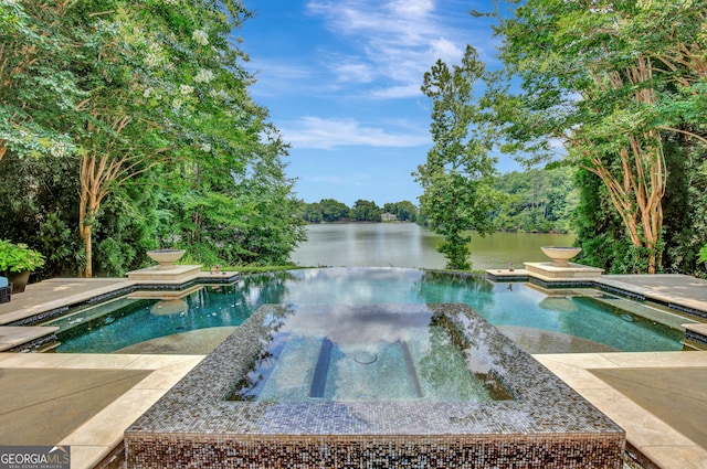 view of pool featuring a patio, an in ground hot tub, and a water view