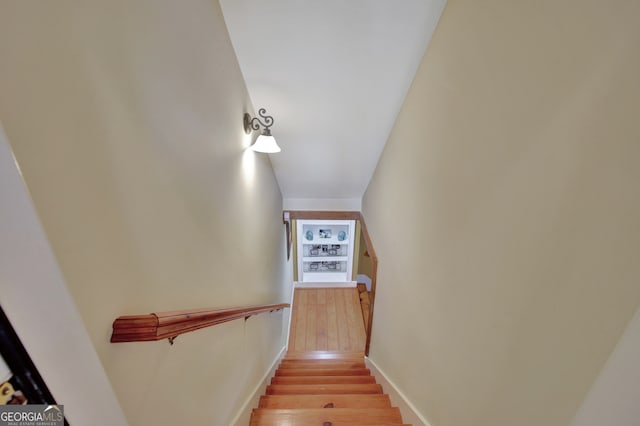 stairway with hardwood / wood-style floors