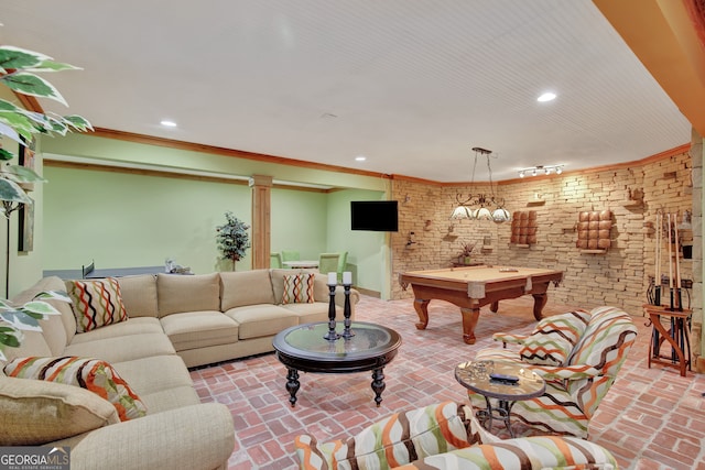 living room featuring pool table, ornamental molding, and brick wall