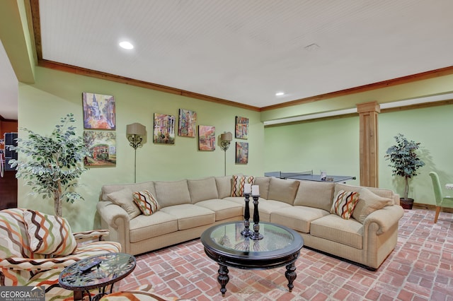 living room featuring ornate columns and crown molding