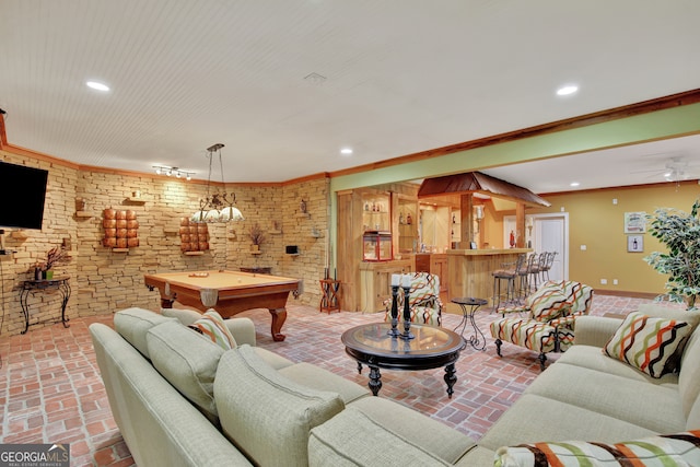 living room featuring pool table, ornamental molding, brick wall, and ceiling fan