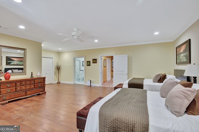 bedroom with connected bathroom, a closet, crown molding, light wood-type flooring, and ceiling fan