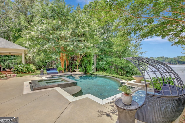 view of swimming pool featuring an in ground hot tub and a patio