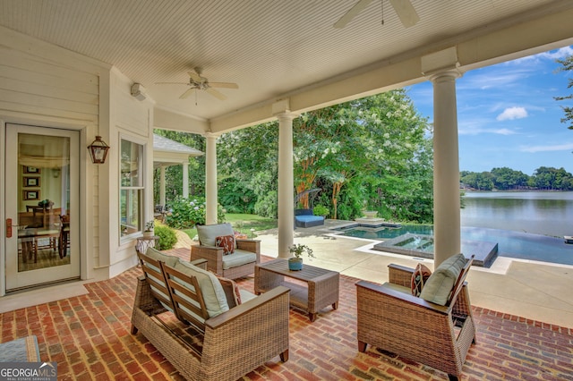 view of patio / terrace featuring outdoor lounge area, a swimming pool with hot tub, a water view, and ceiling fan