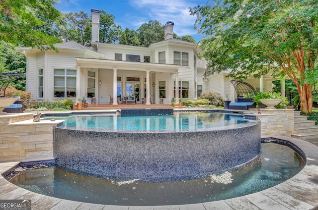 rear view of property featuring a patio area