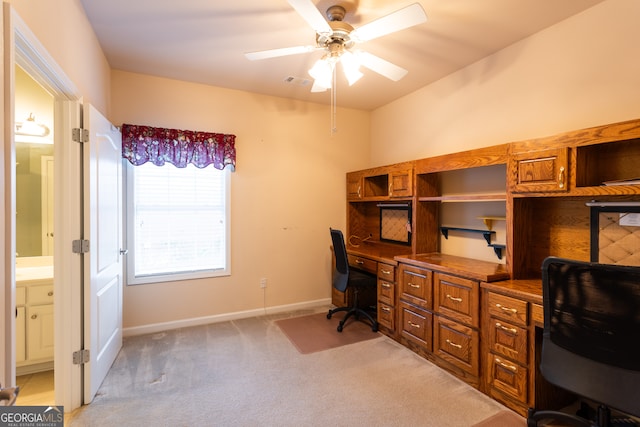 carpeted office with ceiling fan