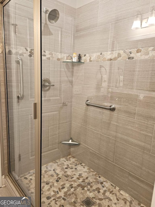 bathroom featuring a shower with door