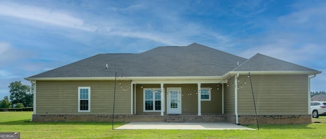 back of property featuring a lawn