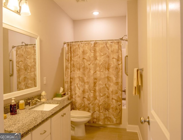 bathroom featuring vanity, tile patterned flooring, and toilet