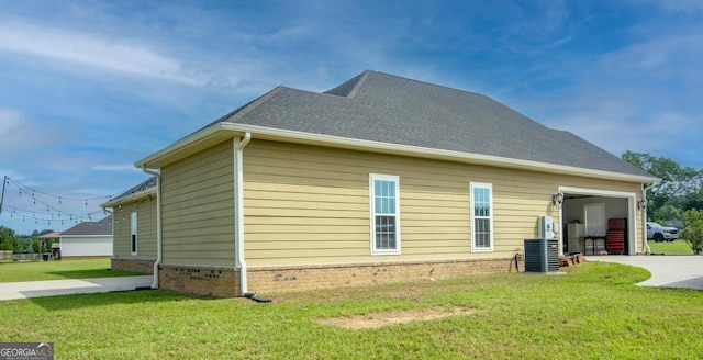 view of property exterior featuring a lawn and central AC unit